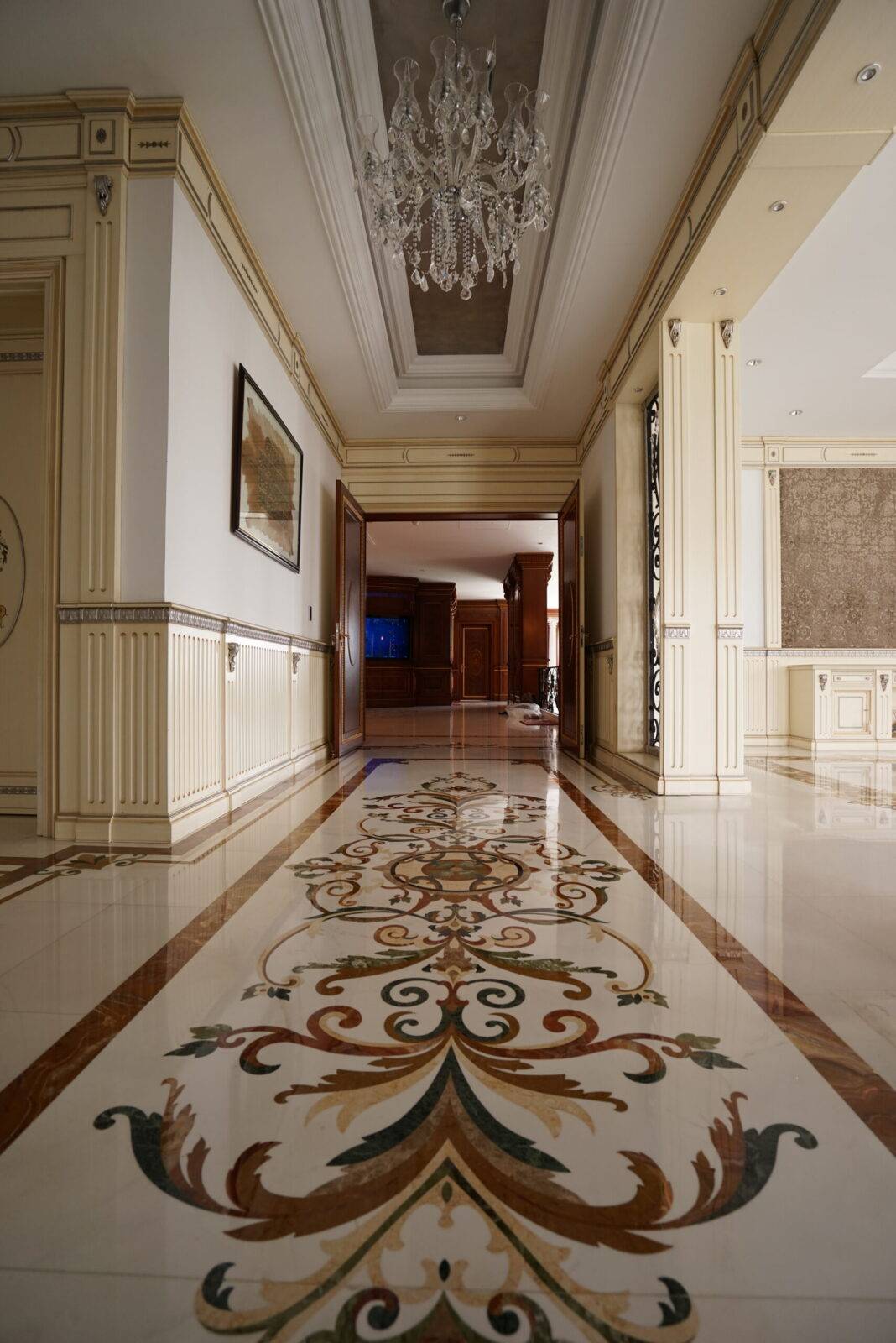 Luxury marble flooring in a Dhaka, Bangladesh residence lobby. Features custom marble inlay and a stunning marble floor medallion.