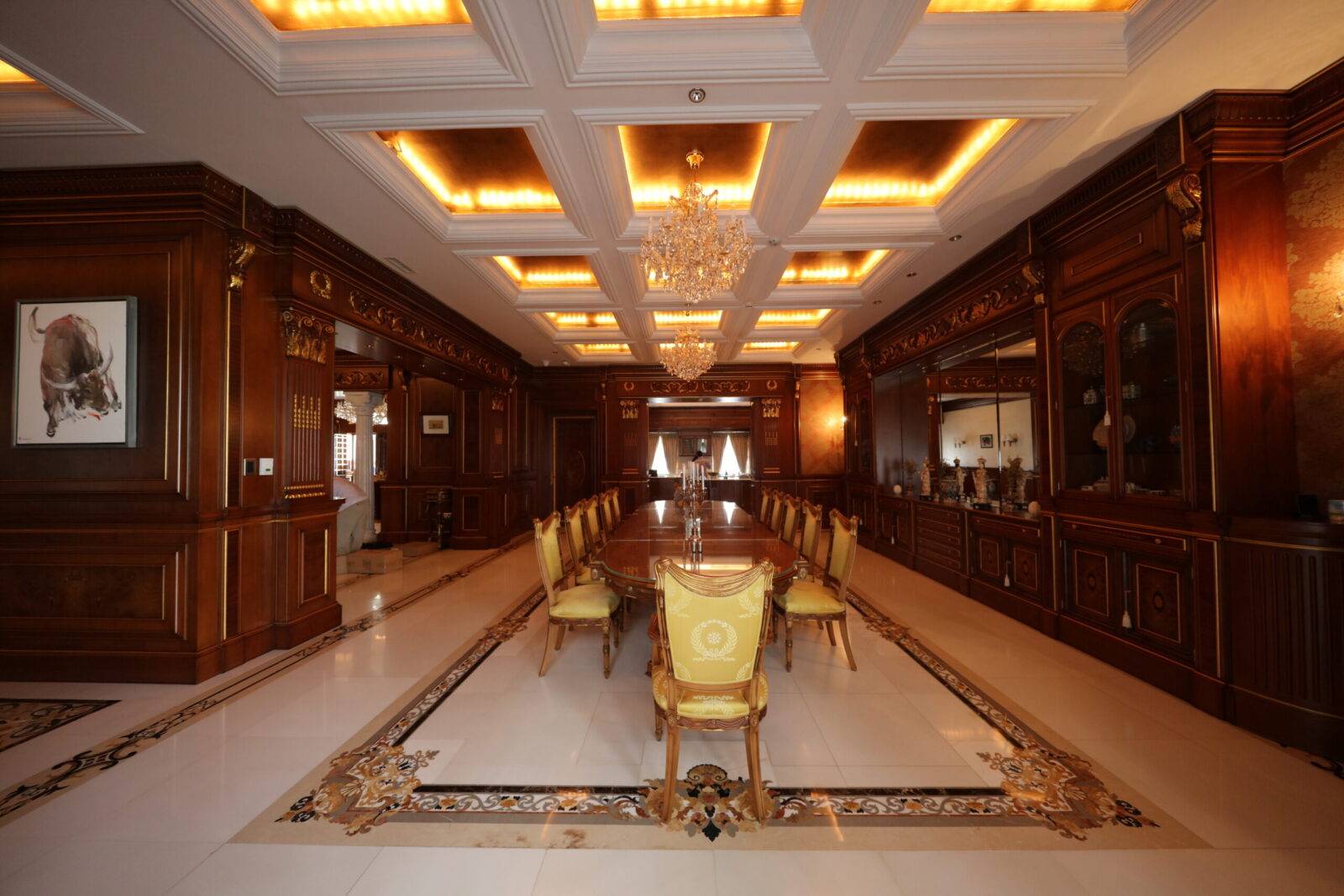 Bangladesh luxury dining room shows marble inlay flooring, custom marble floor medallion, and rich architectural details.