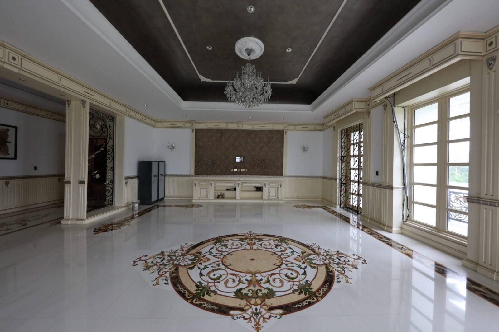 Bangladesh luxury interior featuring a stunning marble floor medallion and intricate marble inlay design. Custom stone craftsmanship visible.