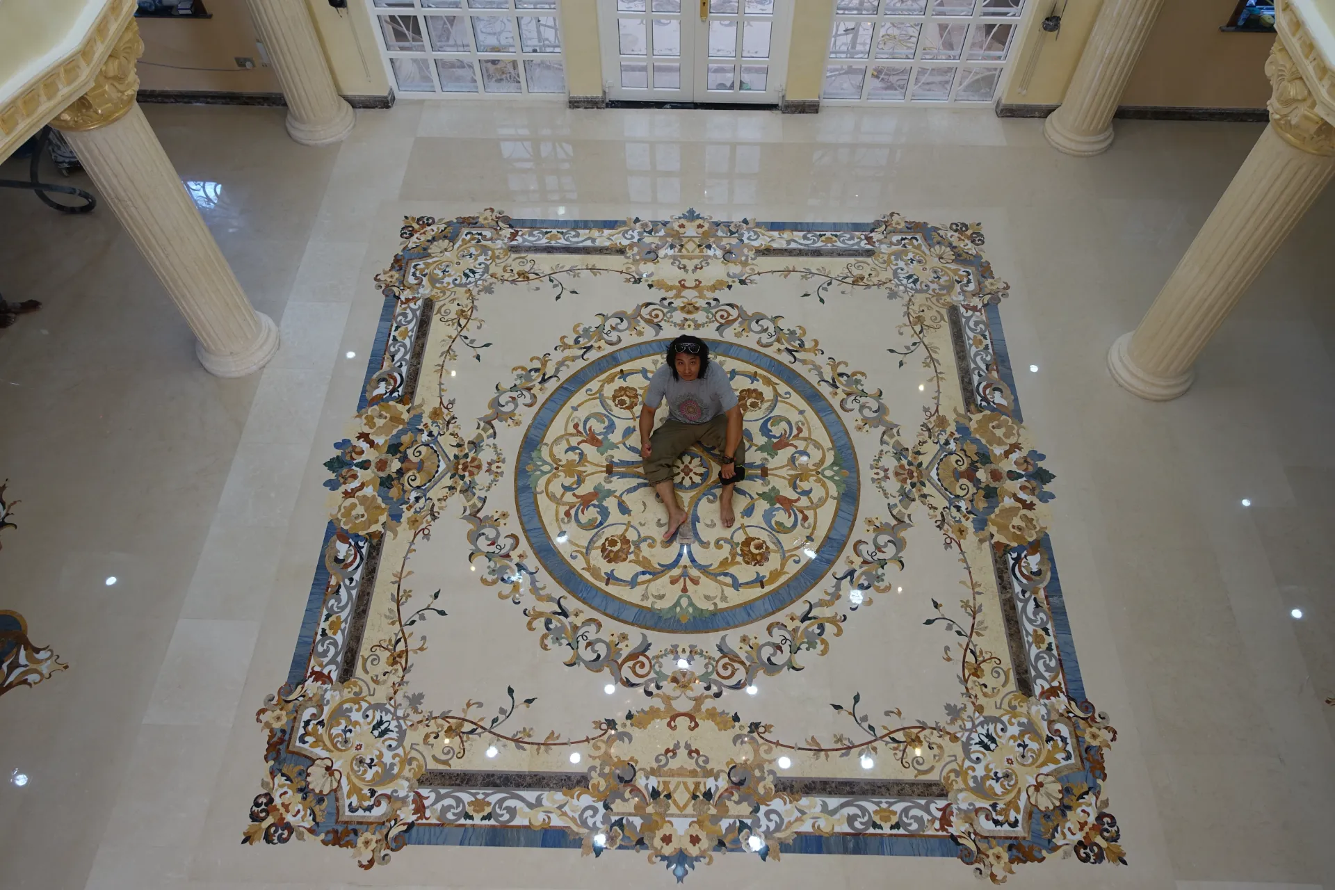 Luxury marble inlay flooring in Tanzania. Intricate custom marble floor medallion. Fine stone inlay design. Pietre dure craftsmanship.