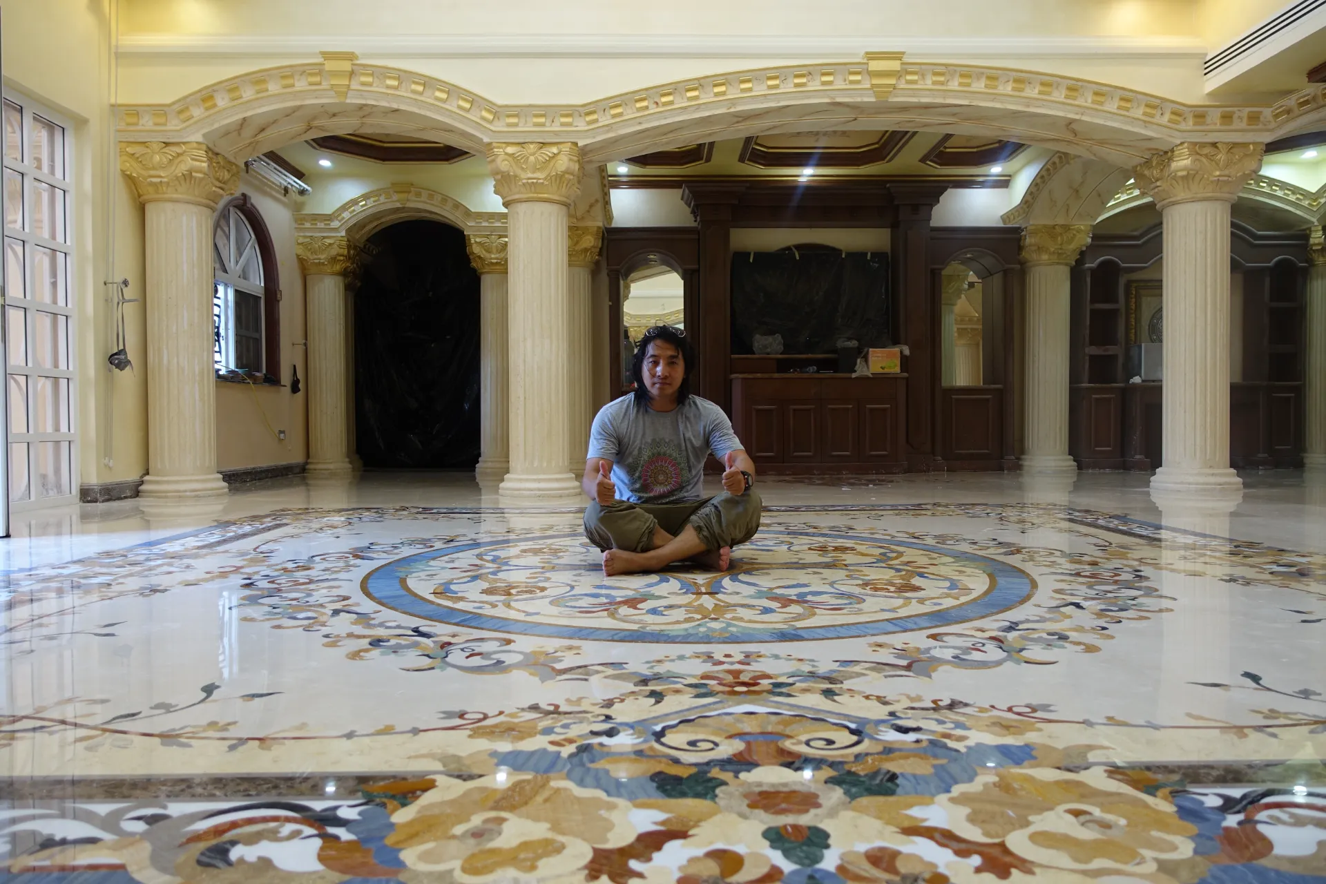 Master artisan inspecting a newly installed marble inlay floor