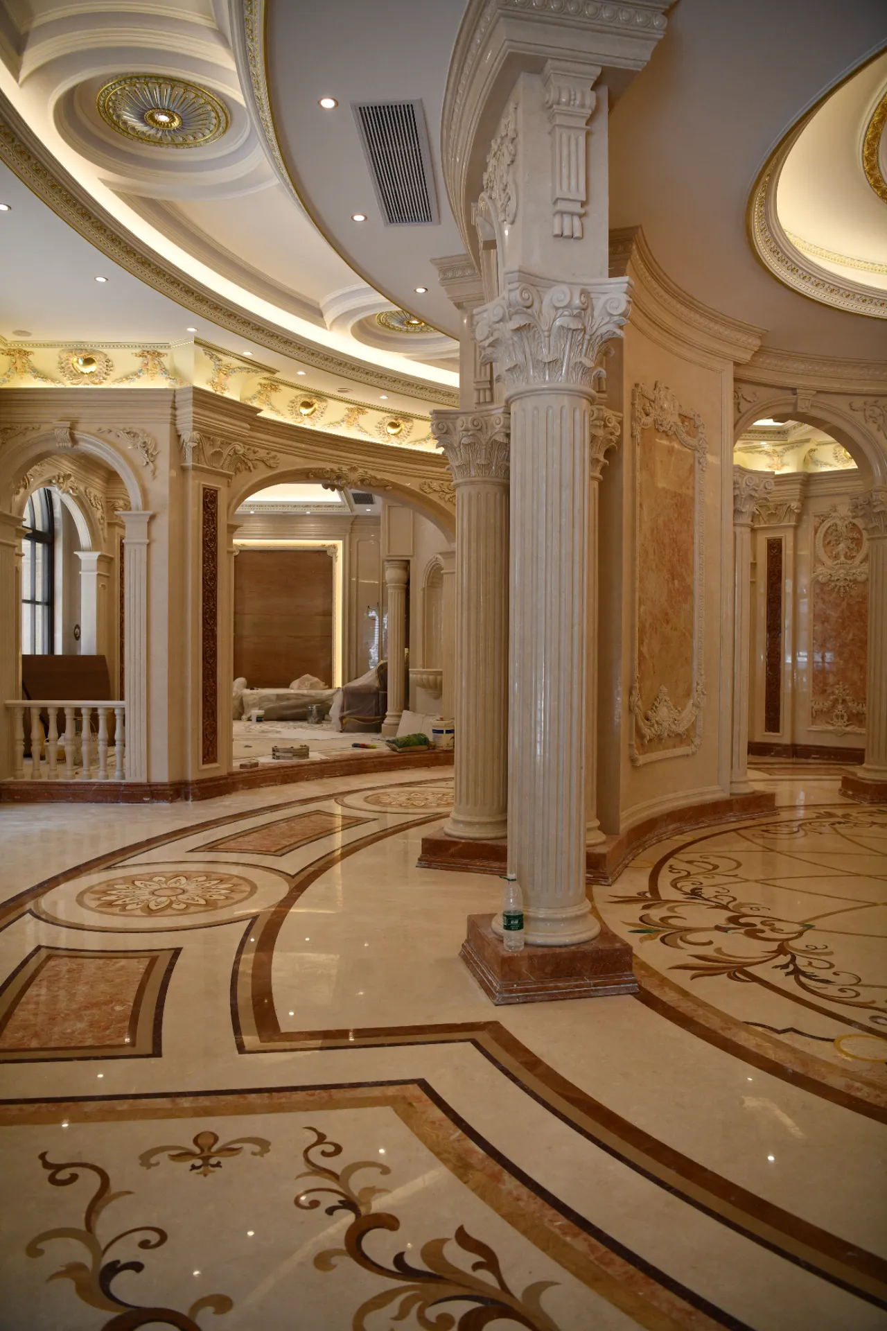 Luxury marble inlay flooring featuring intricate stone inlay design and a custom marble floor medallion