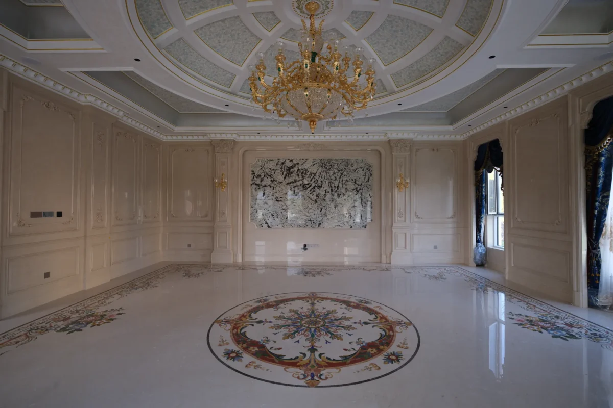 Polished marble floor with a large waterjet medallion and border inlay in a luxury interior.