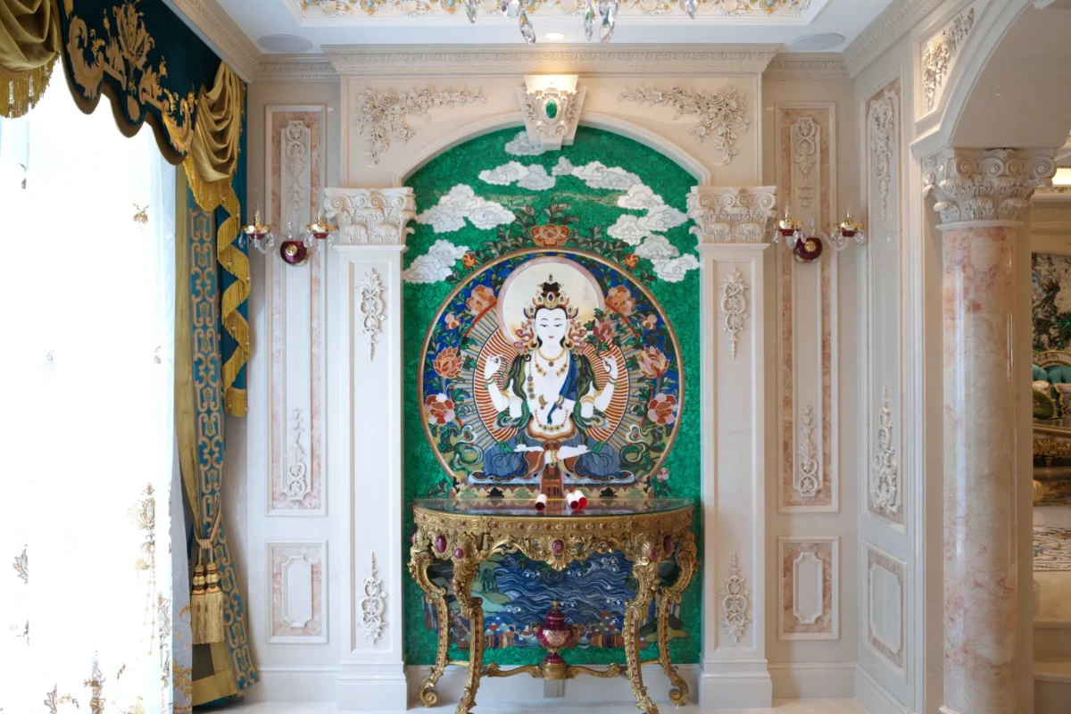 Green marble inlay wall panel featuring a medallion of a seated deity within an ornate arched niche.