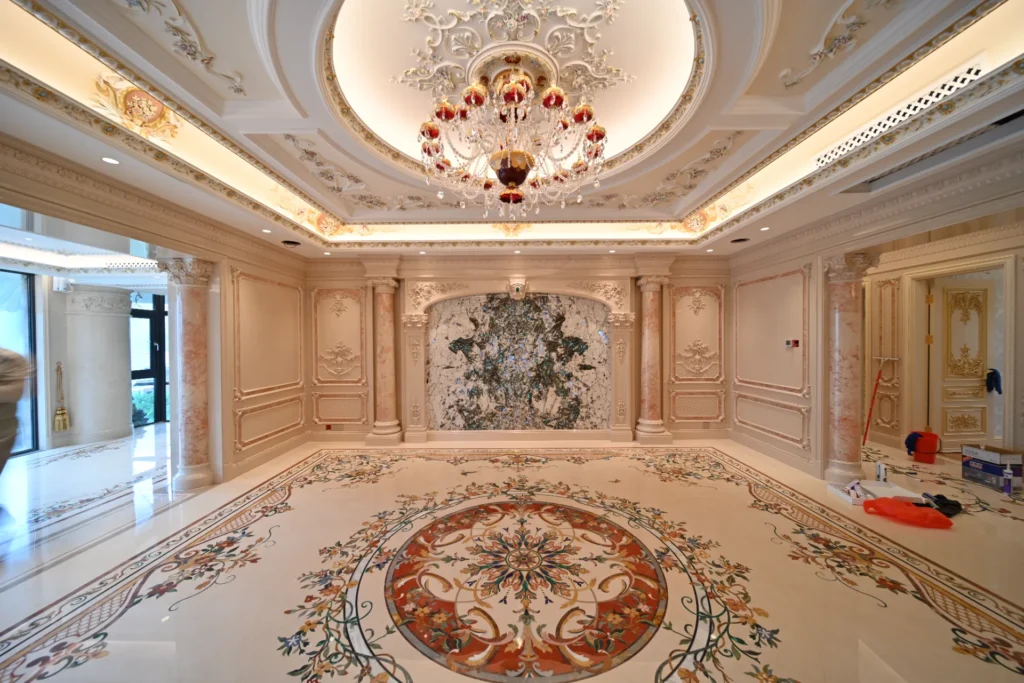Ornate marble floor with a large circular inlay medallion and floral borders in a luxury interior.