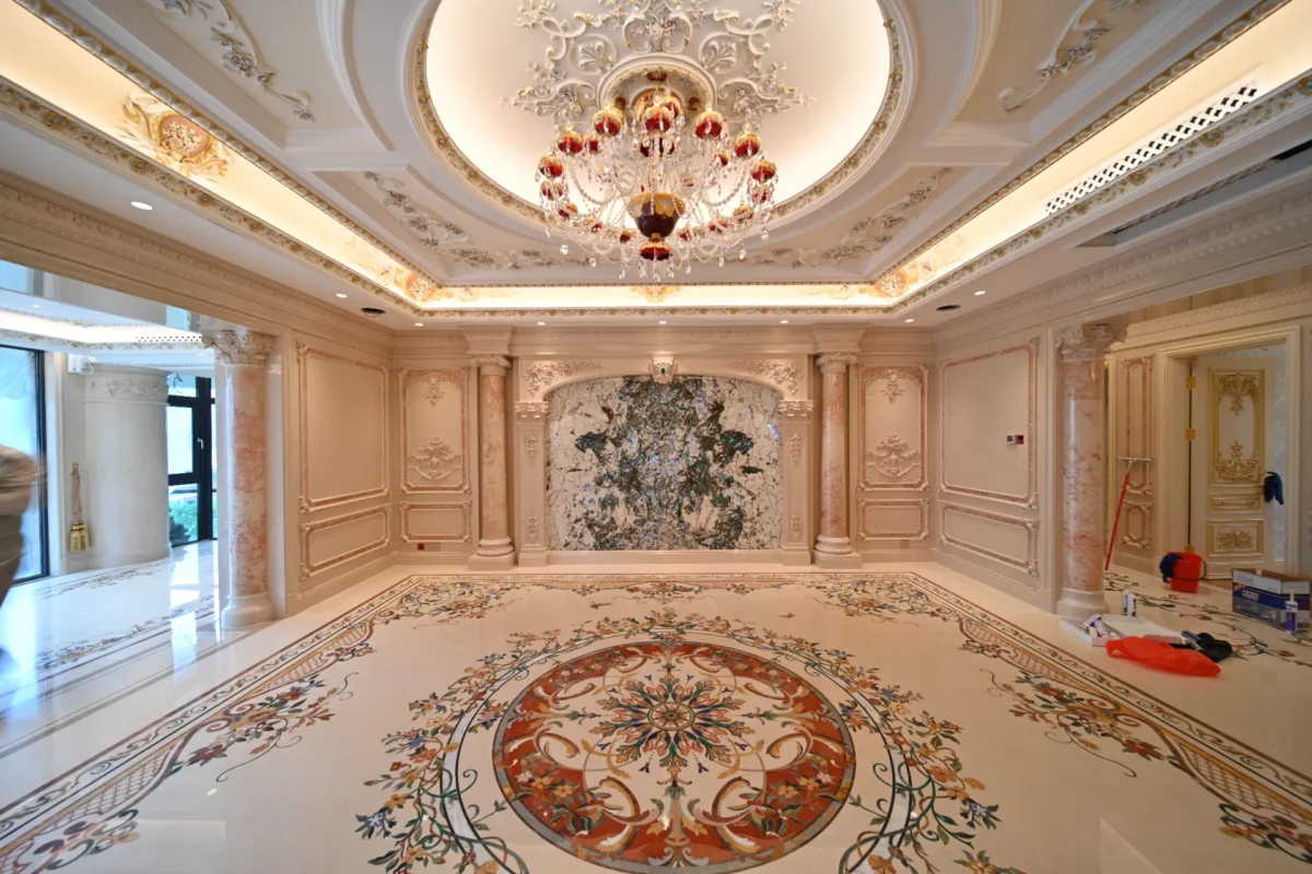 Ornate marble floor with a large circular inlay medallion and floral borders in a luxury interior.