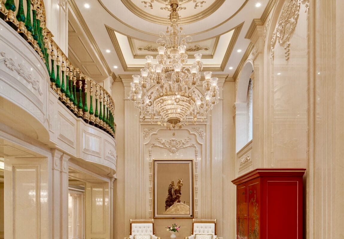 Circular marble inlay medallion set into a polished stone floor within a grand double-height interior.