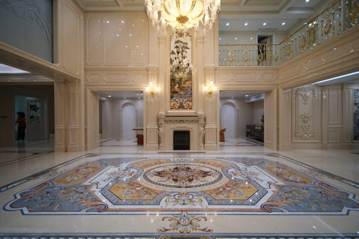 Large marble floor inlay with ornate waterjet medallion in a luxury interior.