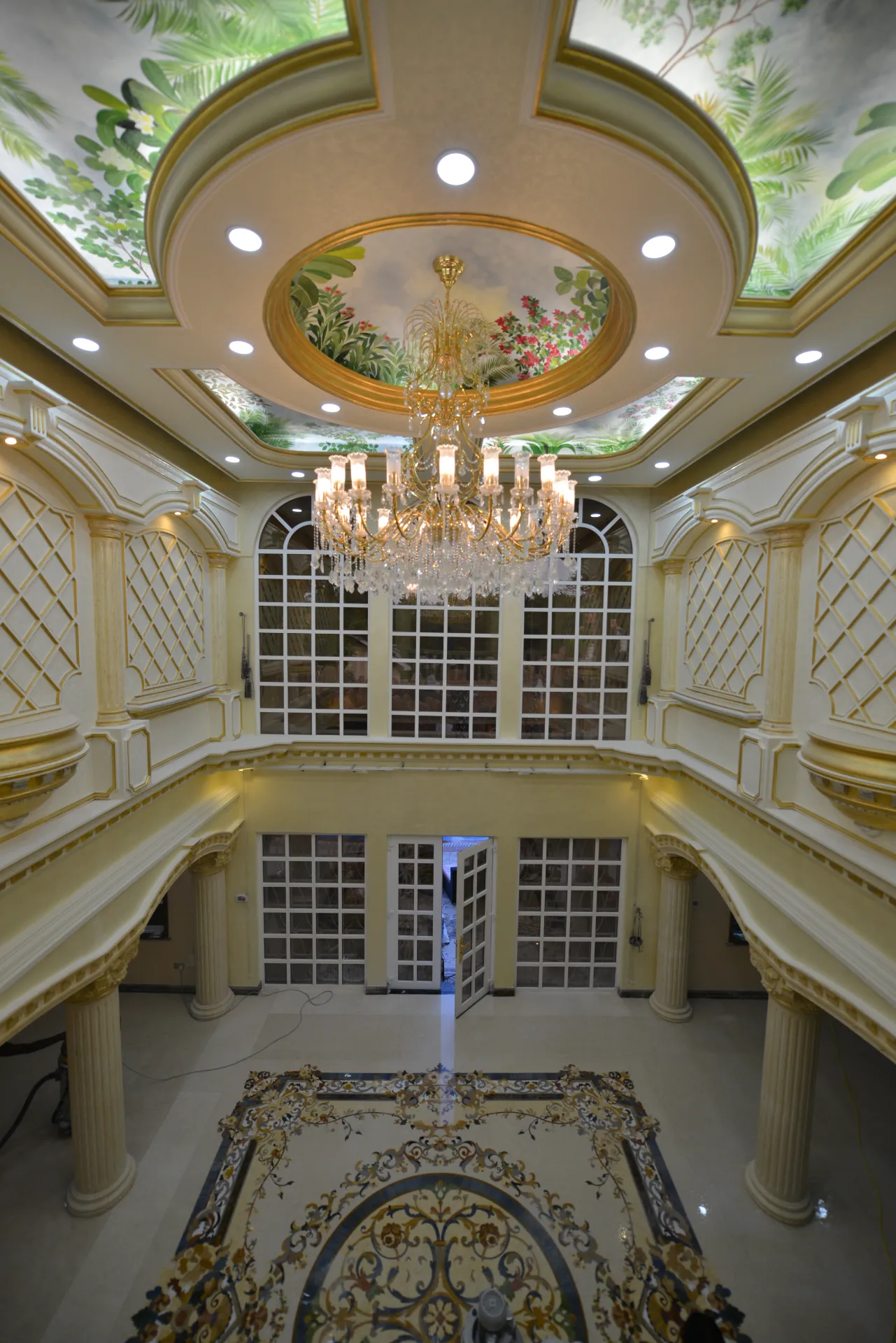 Luxury marble flooring with intricate marble inlay design. Custom stone inlay and floor medallion in Tanzania.
