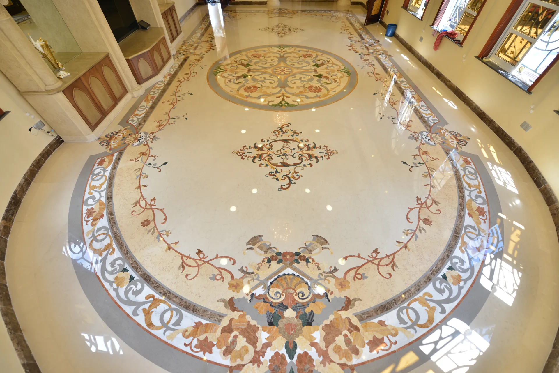 Luxury high-traffic marble floor medallion installed in a grand commercial space.