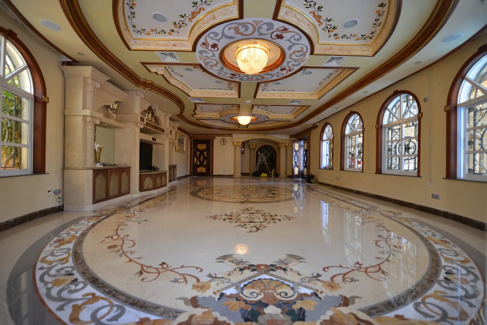 Bespoke marble inlay medallion design featuring dense, durable stones for high-traffic luxury areas.